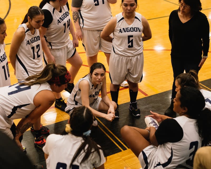 Carmen Estrada talks strategy for Angoon during a timeout against Yakuat as Samara Kasayulie-Kookesh (12), Tricia O'Brien (5) and the rest of the team listens in.