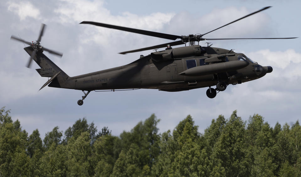 A U.S. Black Hawk UH-60 prepares to land during the combined Lithuanian and U.S. training exercise at the Gaiziunai Training Area some 110 kms (69 miles) west of the capital Vilnius Lithuania, Tuesday, July 7, 2015. (AP Photo/Mindaugas Kulbis)