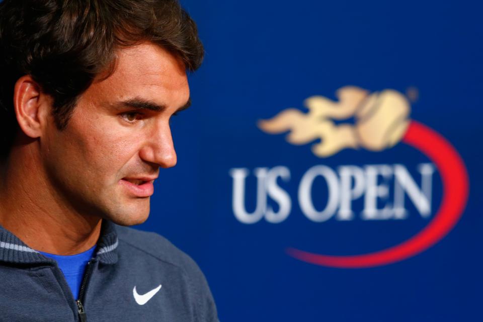 Roger Federer makes his 2014 U.S. Open entrance Tuesday night. (Photo by Julian Finney/Getty Images)