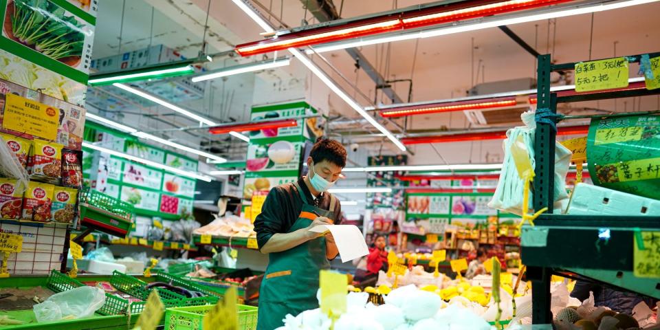 A man inspects products at a supermarket in Beijing, China, on May 12, 2022.