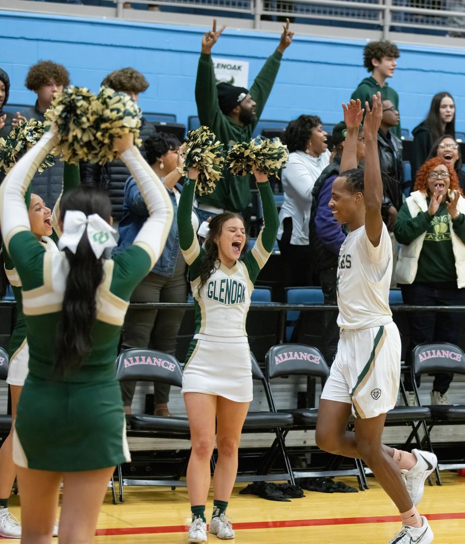 GlenOak’s Jaylen McElroy goes off the court in celebration after defeating McKinley in a district semifinal, Thursday, March 7, 2024.