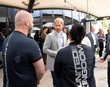 Britain’s Prince Harry and Meghan, the Duchess of Sussex attending a lunchtime Reception hosted by the Prime Minister Scott Morrison with Invictus Games competitors, their family and friends in the city’s central parkland Sydney October 21, 2018. Paul Edwards /Pool via REUTERS