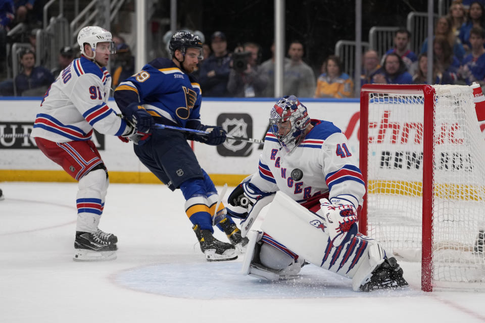 St. Louis Blues' Pavel Buchnevich (89) is unable to score past New York Rangers goaltender Jaroslav Halak (41) as Rangers' Vladimir Tarasenko (91) defends during overtime of an NHL hockey game Thursday, April 6, 2023, in St. Louis. (AP Photo/Jeff Roberson)