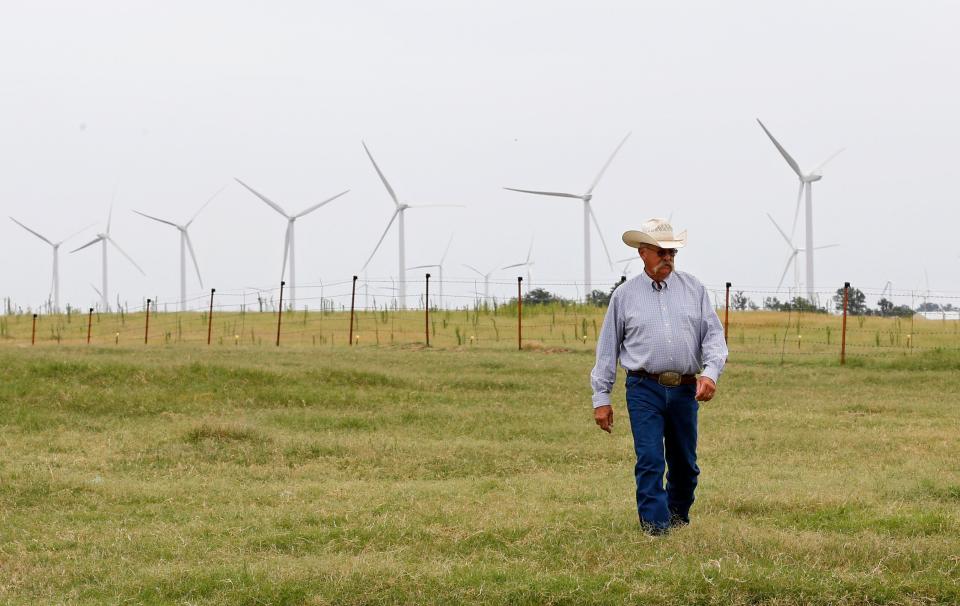 Rick Huffstutlar walks through a pasture at his home