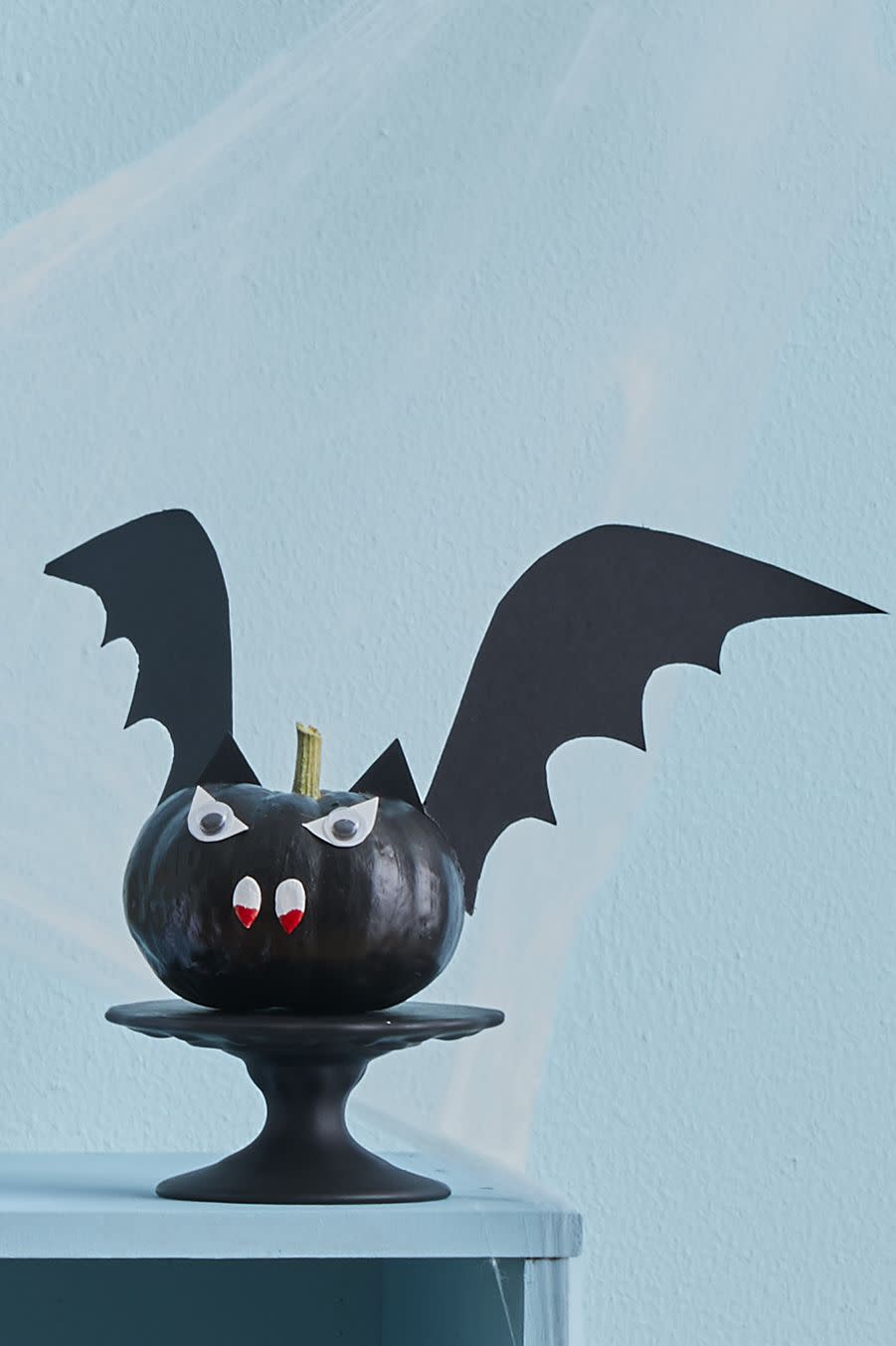 <p>Paint any mini pumpkin all black, use pumpkin seeds for teeth with a hint of blood, of course, cut his ears and wings our of cardstock and glue googly eyes on top of eye-shaped paper cutouts. <strong><br></strong></p><p><a class="link " href="https://www.amazon.com/TOAOB-Assorted-Adhesive-Scrapbooking-Accessories/dp/B01HEDV9SC/?tag=syn-yahoo-20&ascsubtag=%5Bartid%7C10070.g.331%5Bsrc%7Cyahoo-us" rel="nofollow noopener" target="_blank" data-ylk="slk:SHOP GOOGLY EYES;elm:context_link;itc:0;sec:content-canvas">SHOP GOOGLY EYES</a> </p>