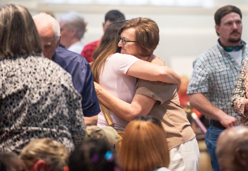 Frieda Owens hugs friends and family after speaking about her daughter, Amy Dicks, who was paralyzed when she was shot by a stray bullet, during a city council meeting at Montgomery City Hall in Montgomery, Ala., on Tuesday, April 16, 2024.