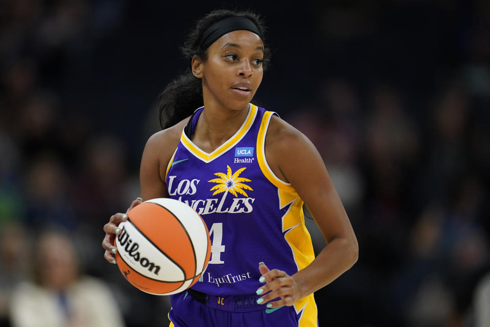 Los Angeles Sparks guard Lexie Brown dribbles downcourt during the first half of a WNBA basketball game against the Minnesota Lynx, Sunday, June 11, 2023, in Minneapolis. (AP Photo/Abbie Parr)