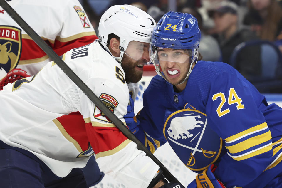 Florida Panthers defenseman Aaron Ekblad (5) and Buffalo Sabres center Dylan Cozens (24) battle for position during the first period of an NHL hockey game Thursday, Feb. 15, 2024, in Buffalo, N.Y. (AP Photo/Jeffrey T. Barnes)