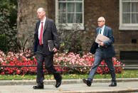 The government's chief medical officer Chris Whitty, left, and chief scientific adviser Patrick Vallance arrive in Downing Street, London, Monday Sept. 21, 2020. Britain’s top medical advisers have painted a grim picture of exponential growth in illness and death if nothing is done to control the second wave of coronavirus infections, laying the groundwork for the government to announce new restrictions later this week. (Yui Mok/PA via AP)