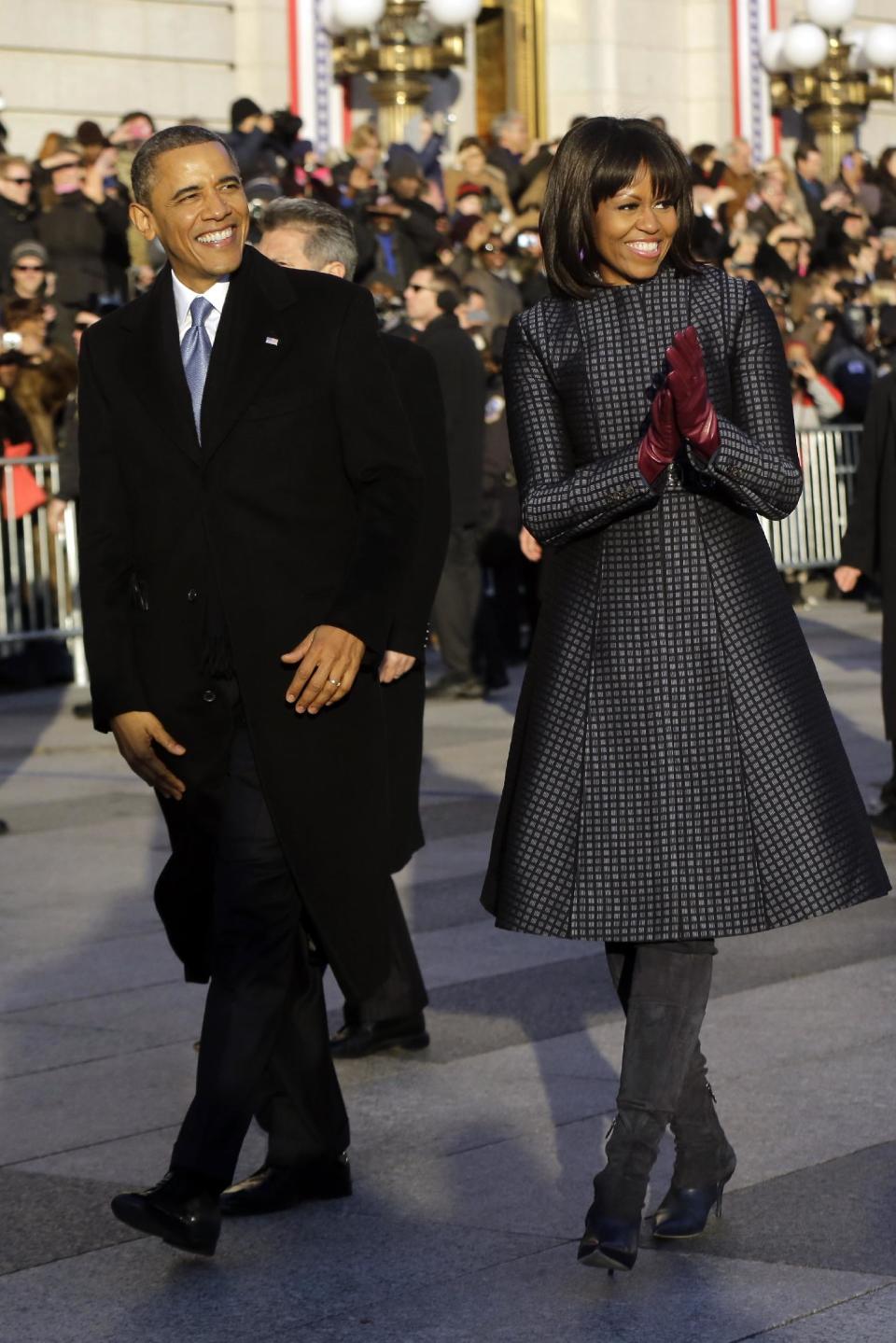 President Barack Obama and first lady Michelle Obama walk in the Inaugural Parade during the 57th Presidential Inauguration in Washington, Monday, Jan. 21, 2013. (AP Photo/Charles Dharapak)