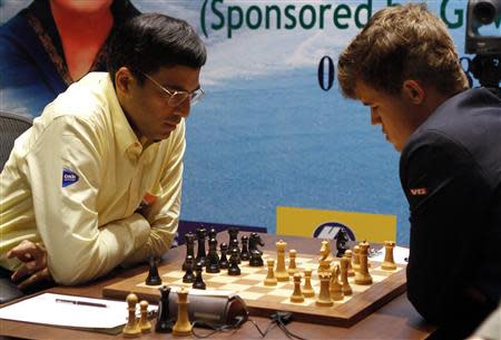 India's Viswanathan Anand (L) plays against Norway's Magnus Carlsen during the FIDE World Chess Championship in the southern Indian city of Chennai November 22, 2013. REUTERS/Babu