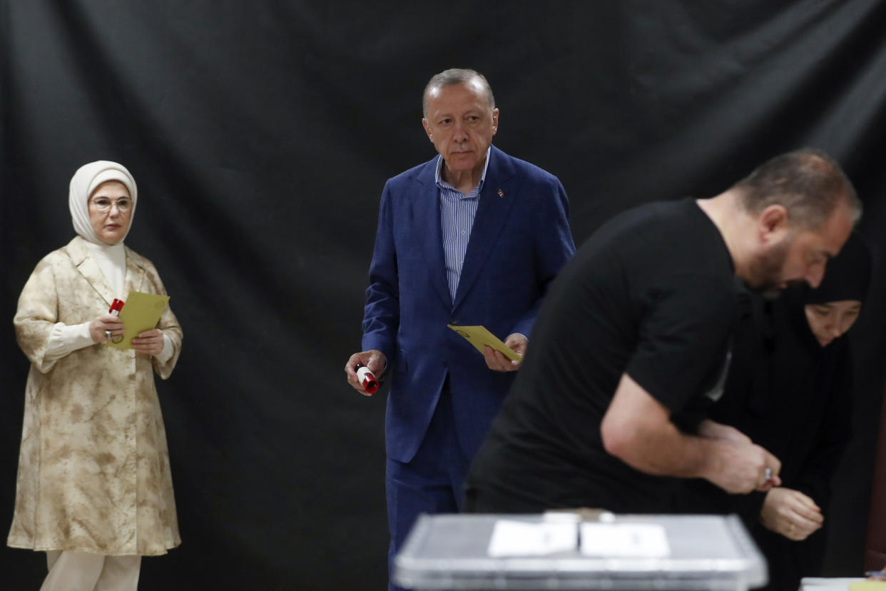 Turkish President Recep Tayyip Erdogan, center, and his wife Emine Erdogan, left, wait to cast their ballots at a polling station during the second round of the presidential election in Istanbul, Sunday, May 28, 2023. Voters in Turkey returned to the polls Sunday to decide whether the country’s longtime leader, Erdogan, stretches his increasingly authoritarian rule into a third decade, or is unseated by a challenger who has promised to restore a more democratic society. (Murad Sezer/Pool Photo via AP)