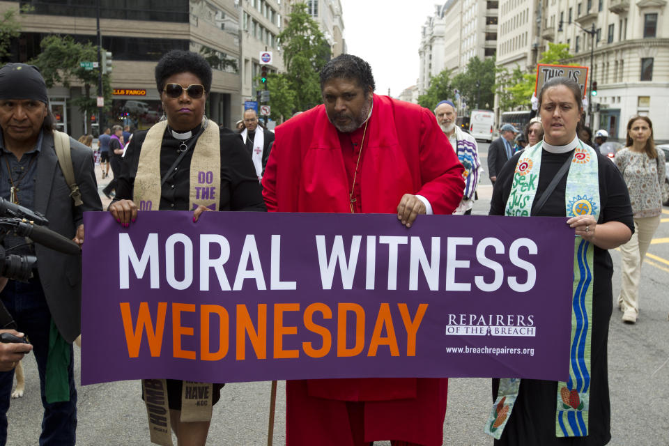 FILE - In this Wednesday, June 12, 2019 file photo, The Rev. Dr William Barber, center, accompanied by faith leaders, march to the White House in Washington protesting against President Donald Trump policies. The Disciples of Christ pastor from North Carolina, a long-time Black civil rights activist, has been outspoken in 2020 in demanding that systemic racism be addressed. (AP Photo/Jose Luis Magana)