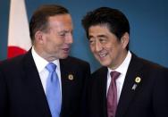 Australia's then Prime Minister Tony Abbott speaks with Japan's Prime Minister Shinzo Abe during a trilateral meeting with U.S. President Barack Obama (not pictured) at the G20 leaders summit in Brisbane November 16, 2014. REUTERS/Ian Waldie/pool