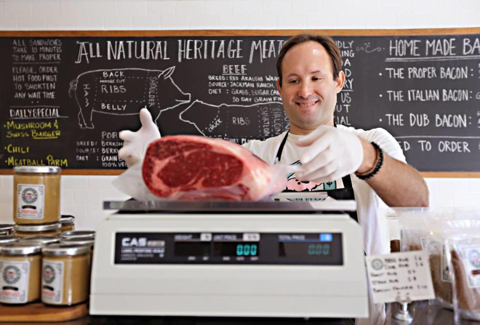 Butcher Freddy Kaufmann weighs a ribeye at Proper Sausages in Miami Shores in 2018.