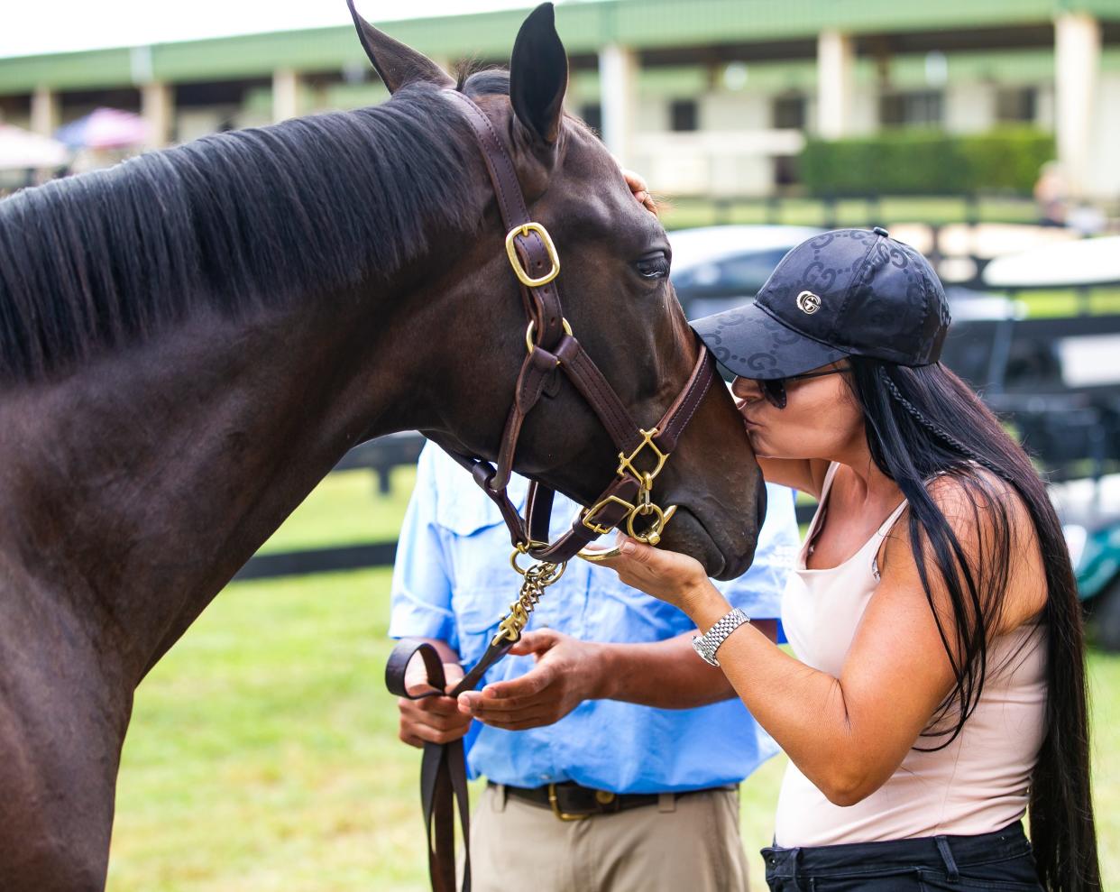 In this file photo from Oct. 11, 2021, Tami Bobo gives Hip 138 a kiss on the nose as potential buyers prior to the October Select Yearlings Sale. Bobo is part owner of 2024 Kentucky Derby contender Catalytic.