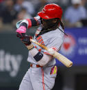 Cincinnati Reds' Elly De La Cruz swings and misses during the first inning of a baseball game against the Texas Rangers in Arlington, Texas, Saturday, April 27, 2024. (AP Photo/Gareth Patterson)