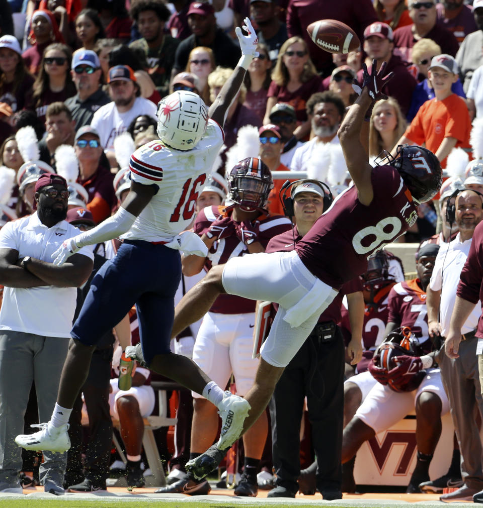 Virginia Tech wide receiver Kaleb Smith (80) attempts to catch a pass while guarded by Richmond's Aamir Hall (16) in the first half of the Richmond Virginia Tech NCAA college football game in Blacksburg, Va., Saturday, Sept. 25 2021. (Matt Gentry/The Roanoke Times via AP)