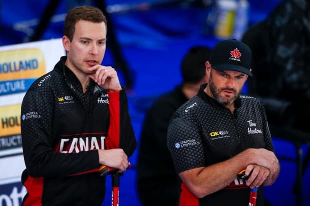 Canada skip Brendan Bottcher, left, third Darren Moulding, right, and the rest of the team face an uphill battle at the men’s world curling championship.  (Jeff McIntosh/Canadian Press - image credit)