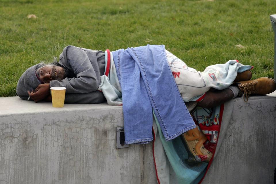 <span class="caption">Biti Arelong, a man experiencing homelessness, rests before the start of tai chi, near the Salt Lake City Public Library, in Salt Lake City.</span> <span class="attribution"><a class="link " href="http://www.apimages.com/metadata/Index/Homeless-Tai-Chi/ae413eabe48c4ed7b3fd4a0bd9301066/64/0" rel="nofollow noopener" target="_blank" data-ylk="slk:AP Photo/Rick Bowme;elm:context_link;itc:0;sec:content-canvas">AP Photo/Rick Bowme</a></span>