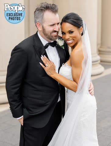 <p>Hunter Hennes Photography</p> Devyn Simone and Adam Lock celebrate at their Kansas City wedding June 24, 2023