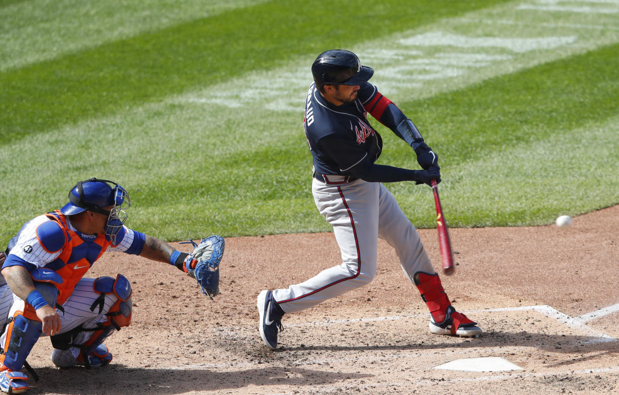 Atlanta Braves' Travis d'Arnaud, right, hits a double against the New York Mets during the sixth inning of a baseball game, Sunday, Sept. 20, 2020, in New York. (AP Photo/Noah K. Murray)