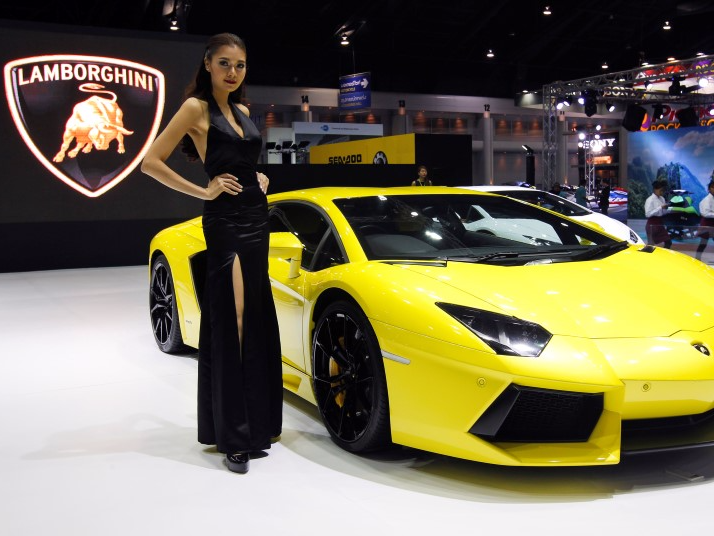 A model poses beside a Lamborghini Aventador LP700-4 during a media presentation at the 37th Bangkok International Motor Show in Bangkok, Thailand, March 22, 2016. REUTERS/Chaiwat Subprasom