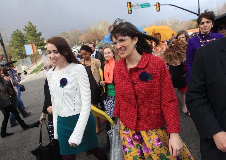 Hannah Wheelwright, left, and Kate Kelly, along with other Mormon women pushing the church to allow women in the priesthood, march to Temple Square during the two-day Mormon church conference Saturday, April 5, 2014, in Salt lake City. The church has asked the women to reconsider, and barred media from going on church property during the demonstration. Mormon officials allowed the women's group to demonstrate its displeasure for not being allowed in an all-male meeting, on church property but still didn't let them attend. (AP Photo/Rick Bowmer)