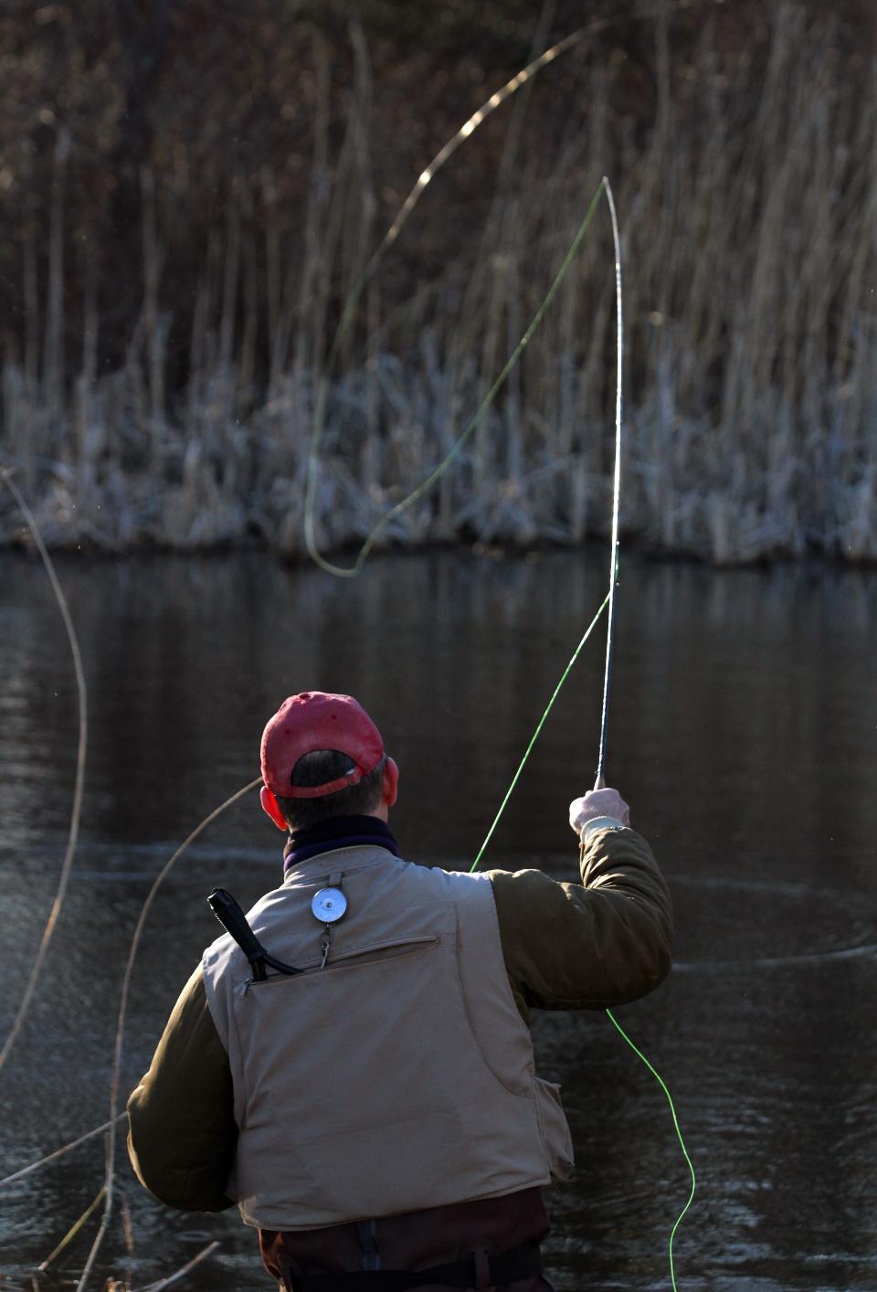 Tom Mooney casts a fly at Smithfield's A.L. Mowry Pond in 2017.