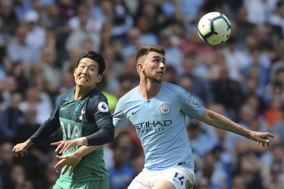 Manchester City's Aymeric Laporte, right, fights for the ball with Tottenham's Heung-Min Son during the English Premier League soccer match between Manchester City and Tottenham Hotspur at Etihad stadium in Manchester, England, Saturday, April 20, 2019. (AP Photo/Rui Vieira)