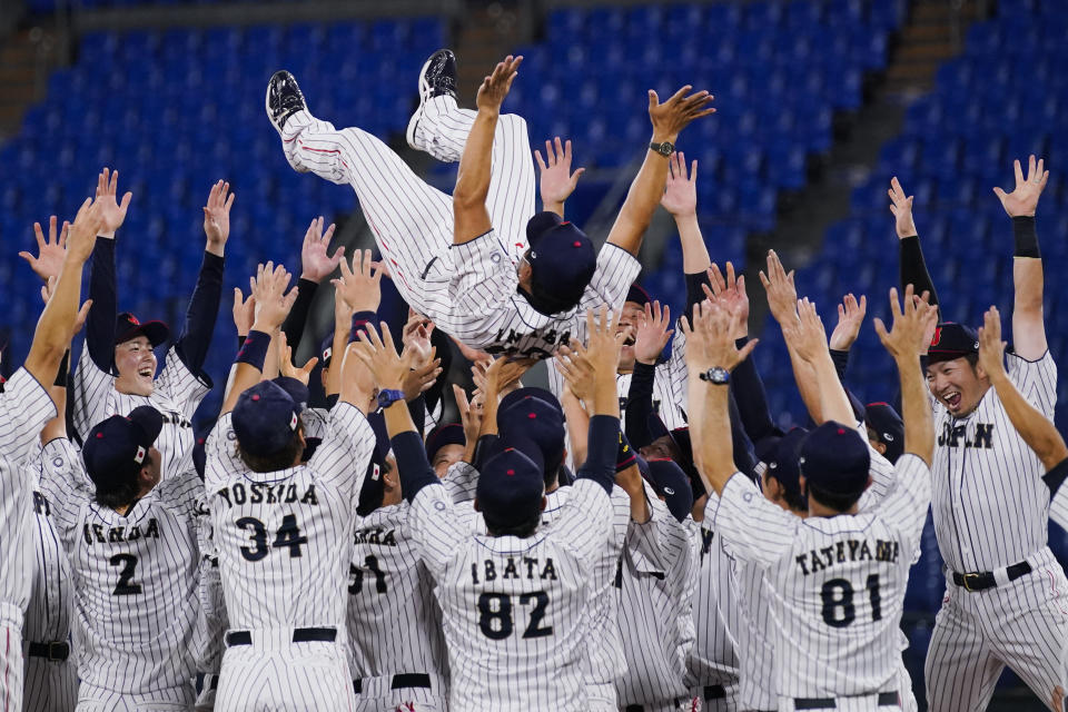 Team Japan celebrate with their manager Atsunori Inaba after the gold medal baseball game against the United States at the 2020 Summer Olympics, Saturday, Aug. 7, 2021, in Yokohama, Japan. Japan won 2-0. (AP Photo/Sue Ogrocki)