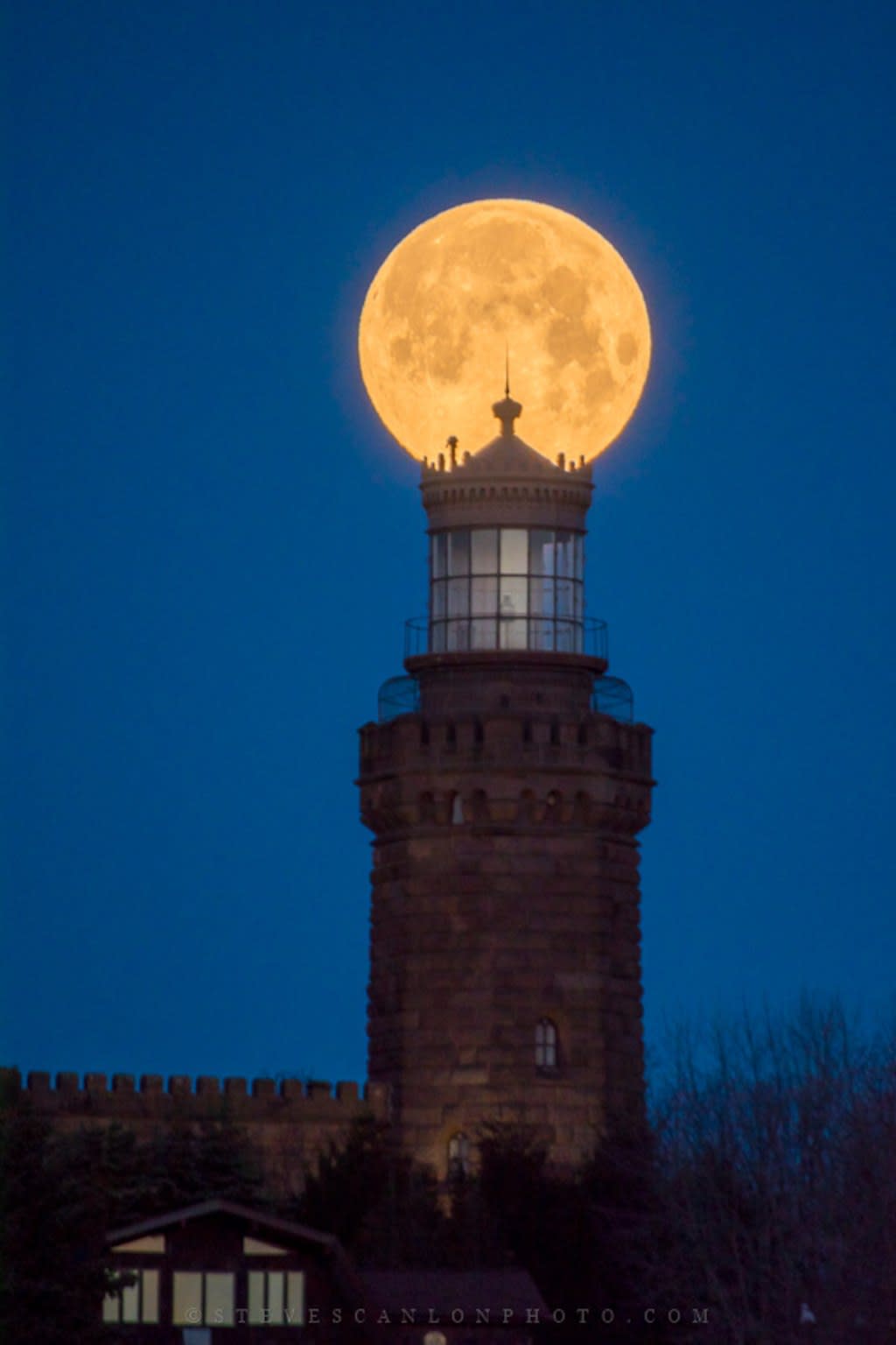 The Blue Sap Moon, seen here above the Navesink Twin Lights lighthouse in Highlands, New Jersey, appears like a celestial beacon for the once-operational tower. Astrophotographer Steve Scanlon captured this image near the historic site at 6:25 a.m. local time on Saturday (March 31). <cite><a href="http://www.stevescanlonphoto.com" rel="nofollow noopener" target="_blank" data-ylk="slk:Steve Scanlon;elm:context_link;itc:0;sec:content-canvas" class="link ">Steve Scanlon</a></cite>