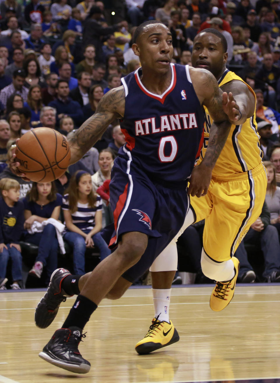 Atlanta Hawks guard Jeff Teague (0) drives past Indiana Pacers guard Donald Sloan in the first half of an NBA basketball game in Indianapolis, Sunday, April 6, 2014. Atlanta won 107-88. (AP Photo/R Brent Smith)