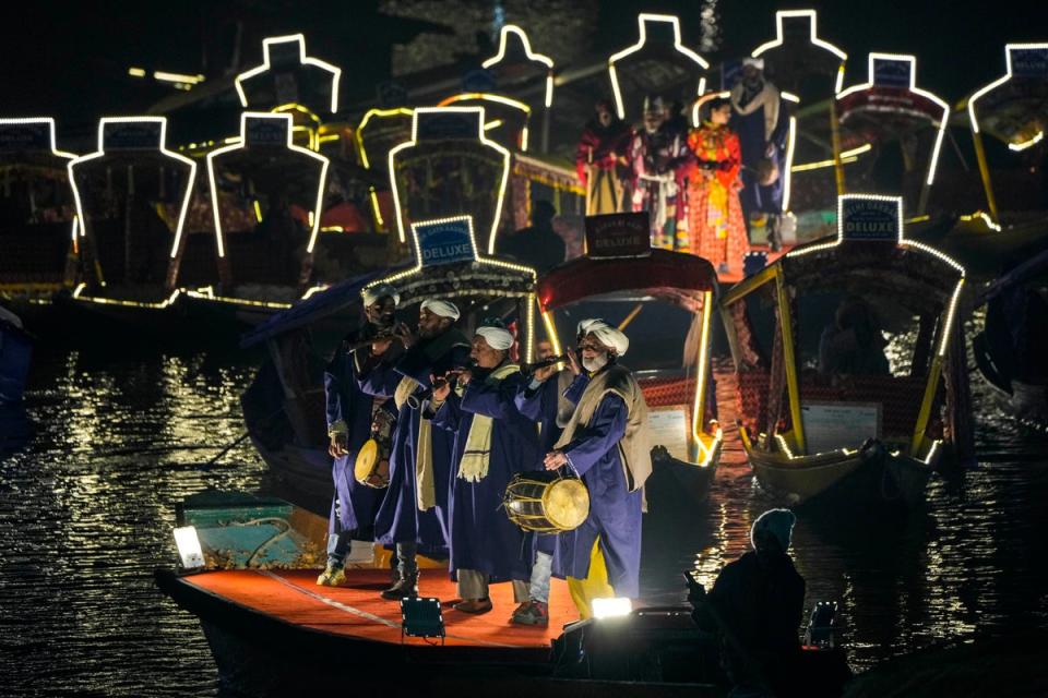 7 December 2022: Folk artists perform during a laser show and live concert at the Dal Lake in Srinagar, Kashmir (AP)