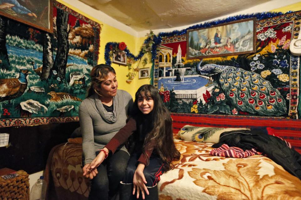 Niculina Fieraru poses with her daughter Flori Gabriela Dumitrache in their room in Gura Sutii village, Romania