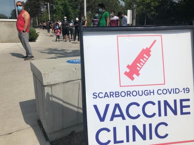 A line forms outside a vaccine clinic at the University of Toronto's Scarborough campus earlier this month. The city says it is opening up thousands of new vaccine appointments. (Robert Krbavac/CBC - image credit)