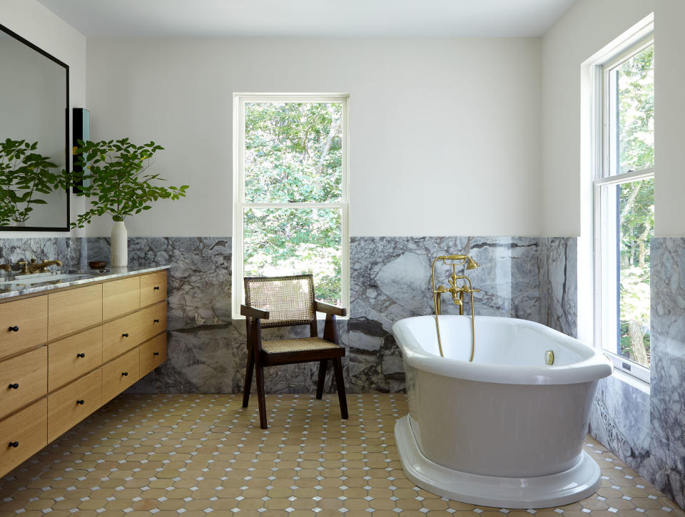 A bathroom with floor and half-wall tiles