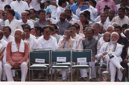 FILE PHOTO: India's Prime Minister Narendra Modi (R) and Mohan Bhagwat (L), chief of the Hindu nationalist organisation Rashtriya Swayamsevak Sangh (RSS), attend the cremation of former prime minister Atal Bihari Vajpayee in New Delhi, India, August 17, 2018. REUTERS/Adnan Abidi/File Photo