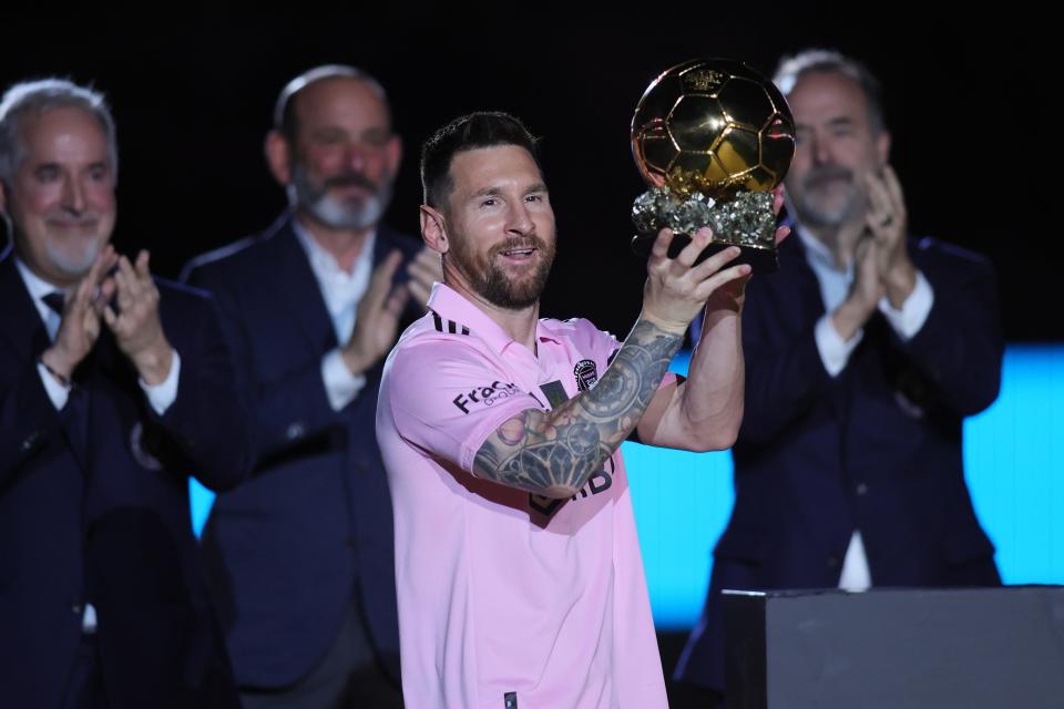 Inter Miami forward Lionel Messi lifts the Ballon d'Or trophy before in a pregame ceremony Friday night.