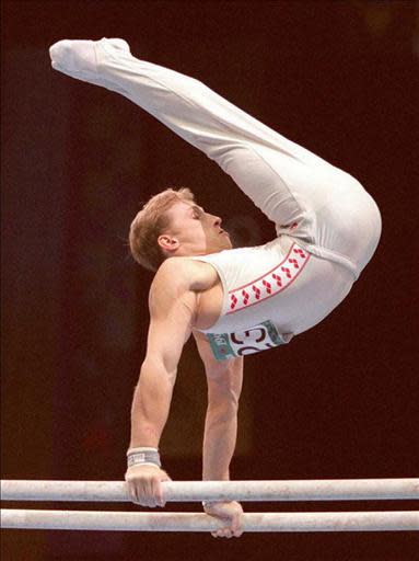 Vitali Scherbo from Belarus performs on the parallel bars 20 July during the men's team compulsories at the Georgia Dome in Atlanta. Scherbo, who won six gold medals at Barcelona, is a favorite for the gold medal in both floor and parallel bar events. (FOR EDITORIAL USE ONLY) AFP PHOTO/IOPP/Eric FEFERBERG