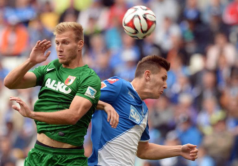 Augsburg's Ragnar Klavan (L) vies with Hoffenheim's Niklas Suele during their German first division Bundesliga match, at Wirsol Rhein-Neckar-Arena in Sinsheim, south-western Germany, on August 23, 2014