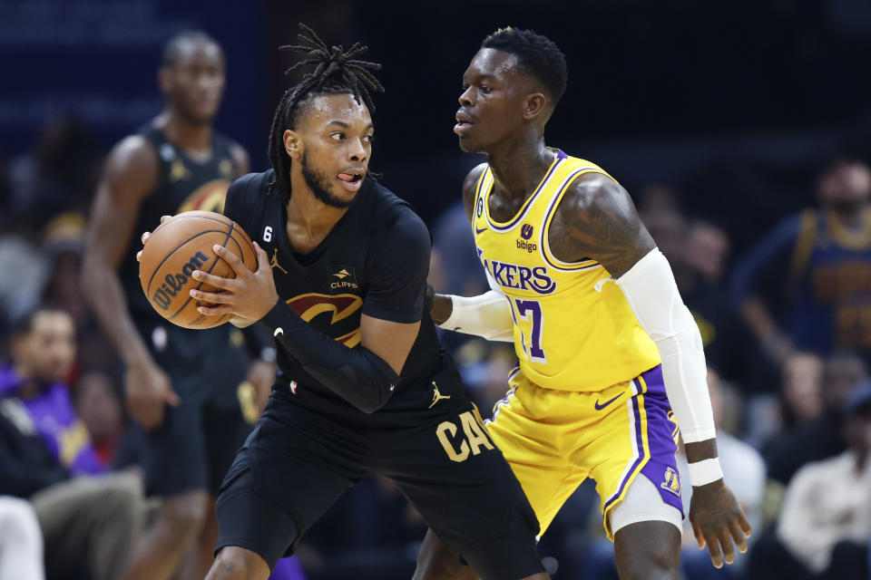 Cleveland Cavaliers guard Darius Garland (10) is defended by Los Angeles Lakers guard Dennis Schroder (17) during the first half of an NBA basketball game Tuesday, Dec. 6, 2022, in Cleveland. (AP Photo/Ron Schwane)