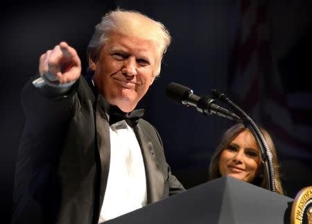 U.S. President Donald Trump points to a guest as he arrives onstage for concluding remarks as first lady Melania Trump looks on, at the Ford's Theatre Gala, an annual charity event to honor the legacy of President Abraham Lincoln, in Washington, U.S., June 4, 2017. REUTERS/Mike Theiler