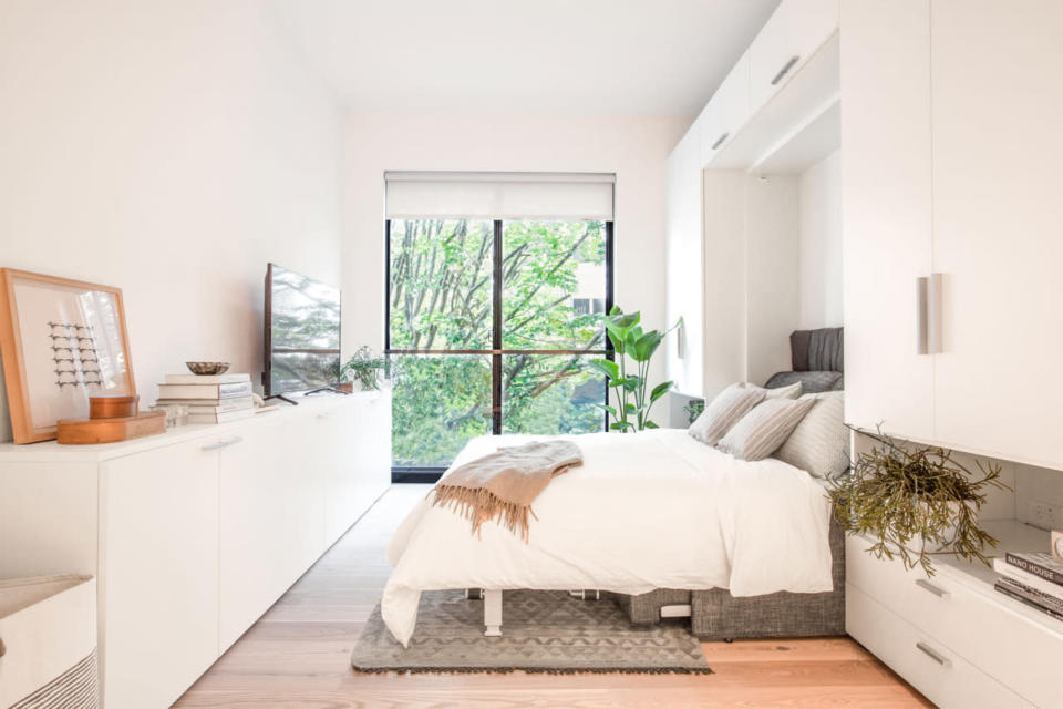 A Murphy bed folds out over the couch, creating an instant bedroom in the living room that can be packed away just as quickly. (Photo: Cameron Blaylock and Mekko Harjo)