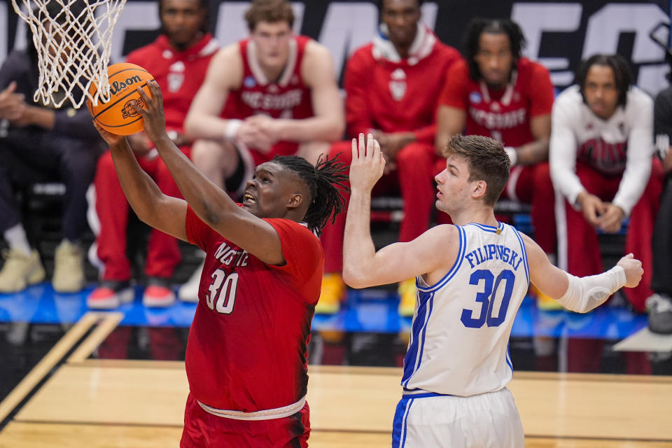 North Carolina State's DJ Burns Jr., left, goes up for a basket against Duke's Kyle Filipowski during the second half of an Elite Eight college basketball game in the NCAA Tournament in Dallas, Sunday, March 31, 2024. North Carolina State won 76-64. (AP Photo/LM Otero)