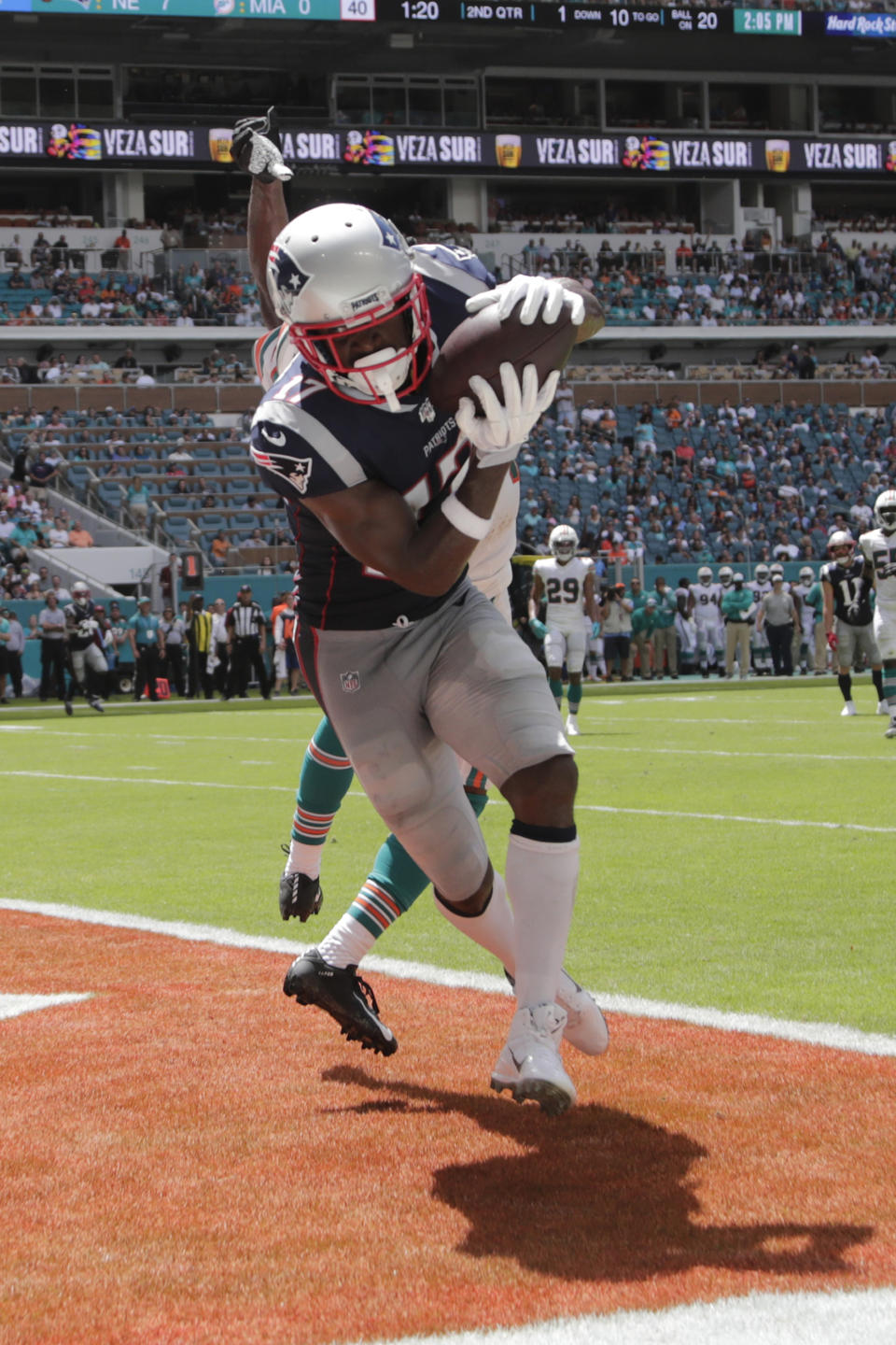 New England Patriots wide receiver Antonio Brown (17) scores a touchdown as Miami Dolphins cornerback Jomal Wiltz (33) attempts to defend, during the first half at an NFL football game, Sunday, Sept. 15, 2019, in Miami Gardens, Fla. (AP Photo/Lynne Sladky)