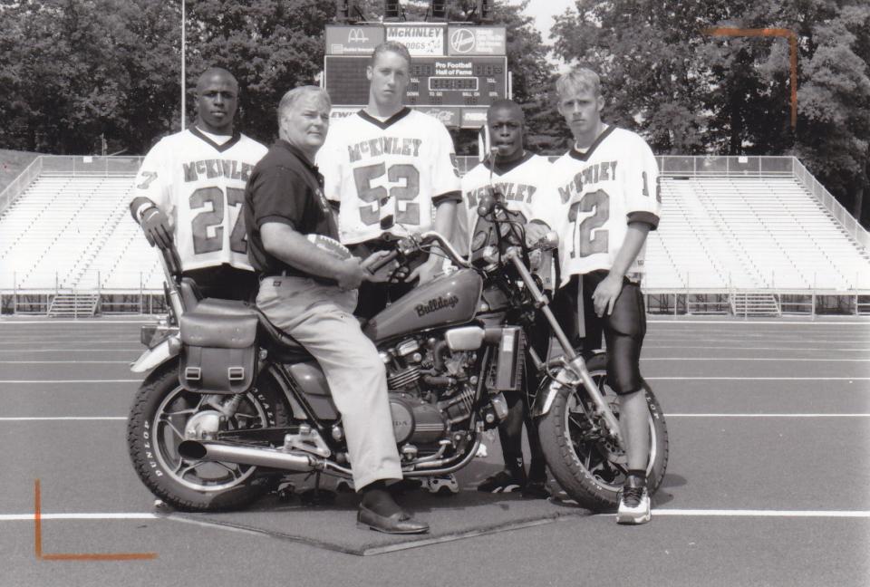 McKinley football coach Kerry Hodakievic poses for a preseason photo with 1998 captains (from left) Mike Doss, Steve Smith, John Lucius and Ben McDaniels.