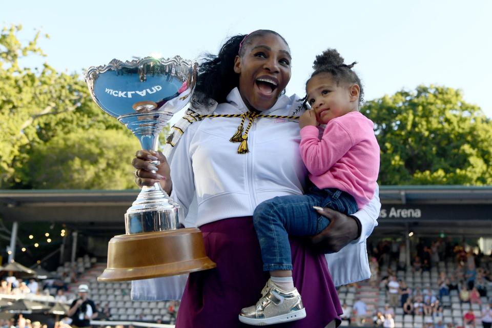 Serena Williams holds trophy and her daughter Alexis Olympia Ohanian