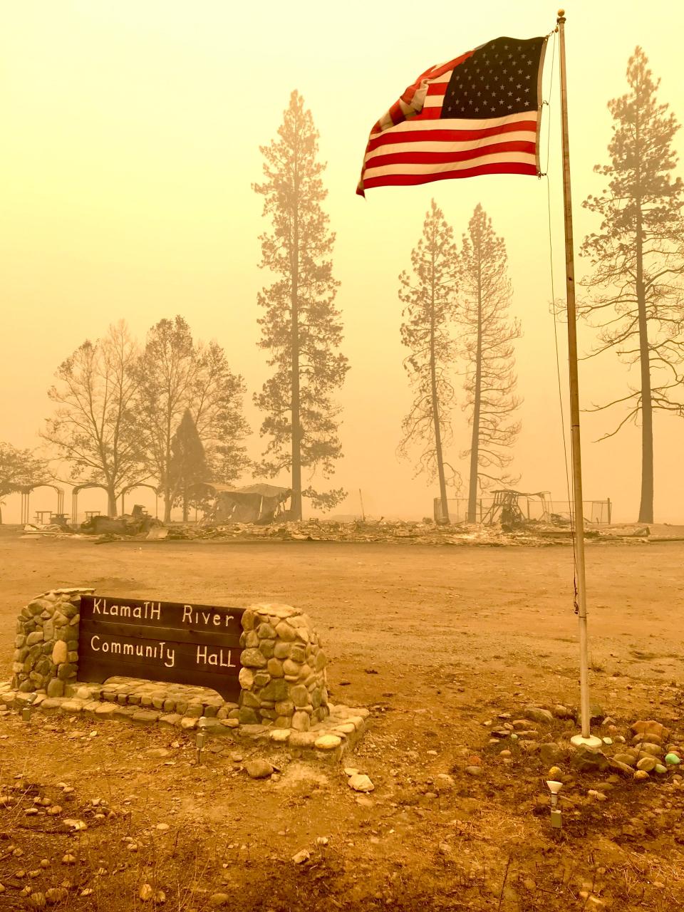 The American flag flies on July 31, 2022, in front of the Klamath River Community Hall, which was destroyed by the McKinney Fire in Siskiyou County.