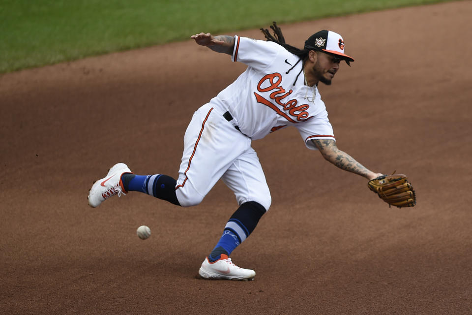 Baltimore Orioles shortstop Freddy Galvis misses a ground ball hit by Seattle Mariners Ty France in the fifth inning of the first game of a baseball doubleheader, Thursday, April 15, 2021, in Baltimore. (AP Photo/Gail Burton)